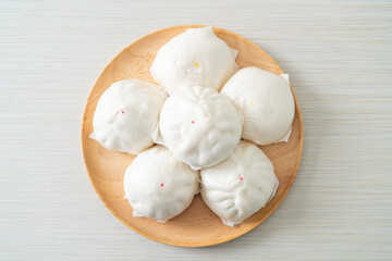 stuffed steamed bun on wood plate