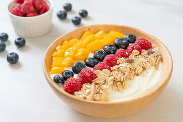 homemade yogurt bowl with raspberry, blueberry, mango and granola