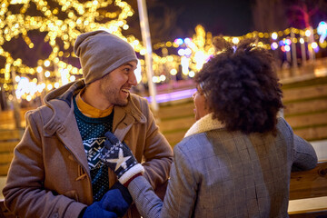 Man and woman dating  at night Street Decorated With Winter Lights