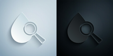 Paper cut Drop and magnifying glass icon isolated on grey and black background. Paper art style. Vector