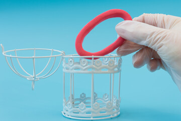 A hand in a medical glove places the omicron virus in a cage. The concept of victory over the coronavirus variant. Omicron is defeated and under control. Vaccination or medication.