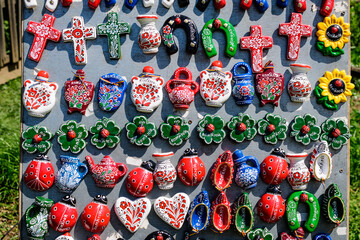 Group of colourful hand painted mixed magnets and suvenirs displayed for sale at a traditional...