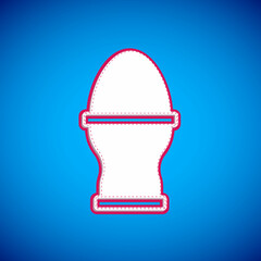 White Chicken egg on a stand icon isolated on blue background. Vector