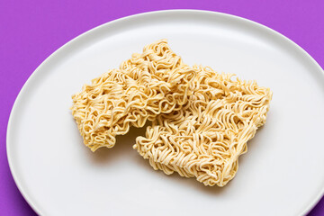 Uncooked Instant Noodles on White Plate. Raw Pasta. Dry Asian Fast Food. Quick Lunch