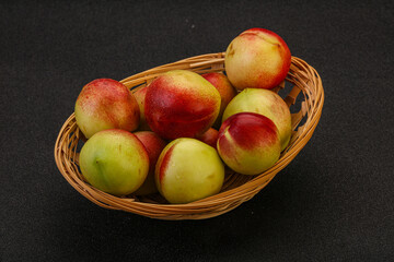 Sweet small nectarines in the basket