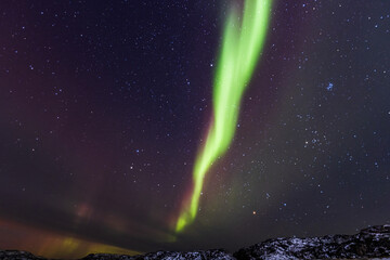 Northern lights with stars. Aurora light. Teriberka village, Murmansk region, Russia.