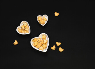 heart shaped cookies on a black background.  Copy space