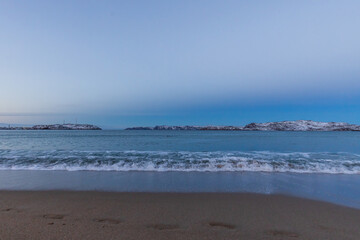 Fototapeta na wymiar Arctic Ocean beach after sunset. Teriberka village, Murmansk region, Russia.
