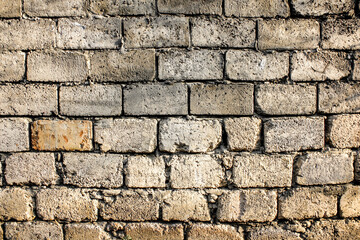 Unfinished brick wall background. Rough brick wall texture.