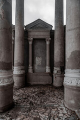 Beautiful ancient architecture with columns. Abandoned palace. Shabby walls. Gray gloomy sky. Monochrome abandoned manor.