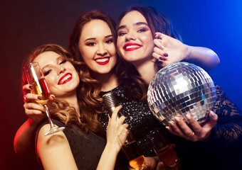 Sensual women in trendy dress happy laughing while her female friend posing with face expression.