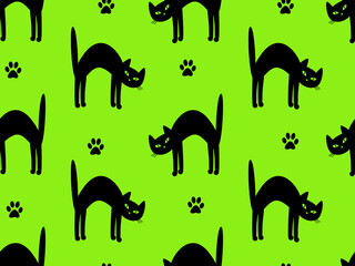 Seamless pattern with black cats on a green background.