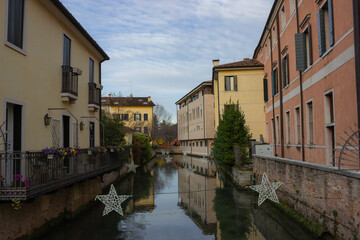 Naklejka na ściany i meble View of the canal and the historic buildings of the city. Treviso, Italy.