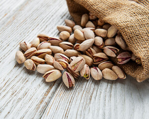 Sack with pistachios on a wooden table