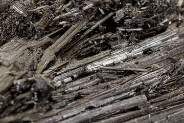 Macro stone black mineral tourmaline Scherl on white background