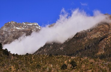 snowy mountain with clouds