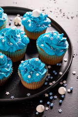 Beautiful cupcakes made of blue cream for fat thursday.