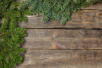 Fir branches on vintage wood table. Rustic style. Top view of a Christmas workplace.