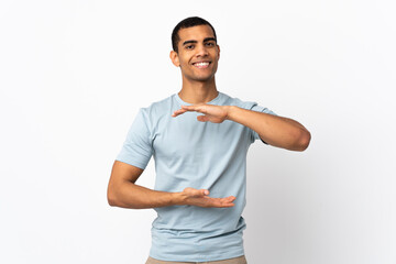 African American man over isolated white background holding copyspace imaginary on the palm to...