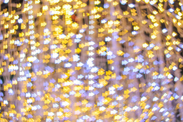 Blurred bokeh background created by the Christmas lights to celebrate the New Year. Beautiful Christmas lights backgrounds and backdrop can be used for any design Or a Christmas greeting card.