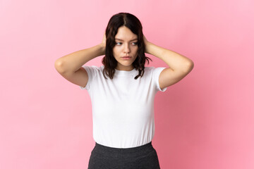 Teenager Ukrainian girl isolated on pink background frustrated and covering ears