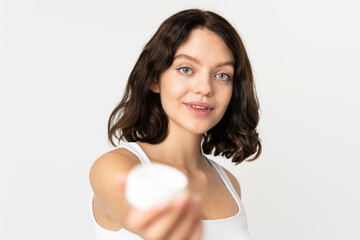 Teenager Ukrainian girl isolated on white background with moisturizer and offering it