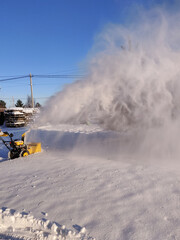Cleaning the yard with snow blower in winter, seasonal activity.