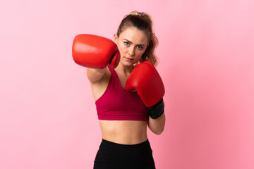 Young Brazilian woman isolated on pink background with boxing gloves