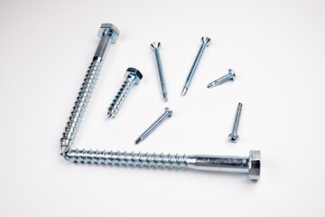 Small self-tapping screws on a white background in the center. Self-tapping frame