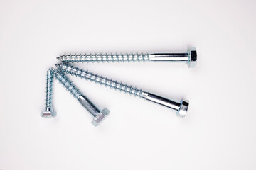 Small self-tapping screws on a white background in the center. Self-tapping frame. 