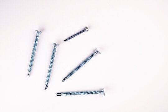 Self-tapping screws on a white background close-up. Self-tapping screw flugel on a white background