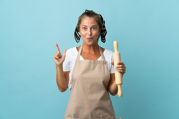 Middle age woman in chef uniform intending to realizes the solution while lifting a finger up