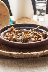 rabbit meat served in tagine on the table