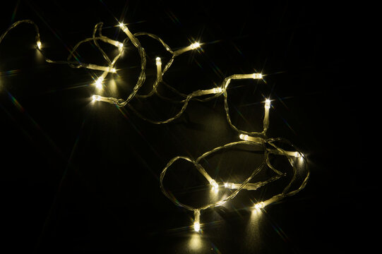 Golden Christmas lights in darkness