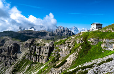 Fototapeta na wymiar Alpine Landscape With Mountain Peaks And View To Rifugio Auronzo On Mountain Tre Cime Di Lavaredo In South Tirol In Italy