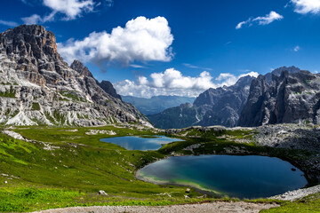 Naklejka na ściany i meble Alpine Landscape With Mountain Peaks And Clear Lakes At The Formation Tre Cime Di Lavaredo In The Dolomites Of South Tyrol In Italy