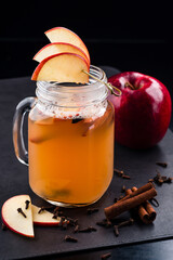 Hot Toddy Cocktail with apple, Lemon, Rum On Dark Background