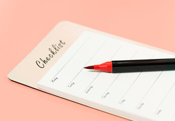 Worksheet with a plan of actions for the week and a red marker on a pink background.