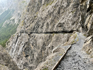 Spectacular rock path, II Quar, in the Val d'Uina canyon, Grisons, Graubuenden, Switzerland.