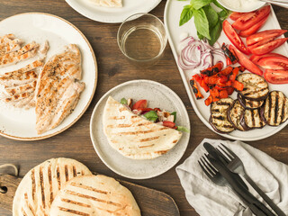 Pita with grilled vegetables, paprika, raw onion, eggplant, tomato, chicken and basil with sauce.