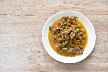 spicy boiled slice beef with eggplant in coconut milk red curry soup on dish