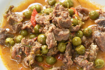 spicy boiled slice beef with eggplant in coconut milk red curry soup on dish