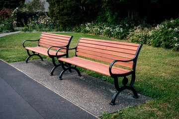 Two wooden benches with iron cast frames in park