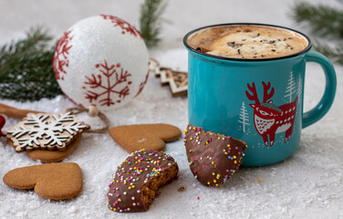 Christmas cookies and a cup of coffee cacao on the table