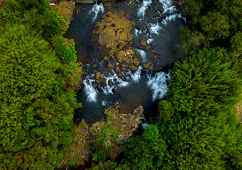 Naklejka na ściany i meble Aerial long exposure view of a hidden waterfall during sunset in Mauritius