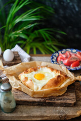 Adjaruli (Acharuli) Khachapuri, Georgian cheese bread. Traditional Georgian recipe made with a bread dough, filled with cheese and crowned with an egg and a butter. 