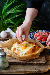 Adjaruli (Acharuli) Khachapuri, Georgian cheese bread. Traditional Georgian recipe made with a bread dough, filled with cheese and crowned with an egg and a butter. 