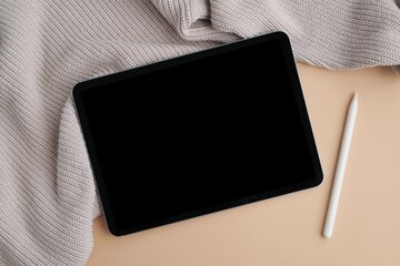 Tablet with blank screen for design, web page, text presentation, flat lay with sweater and pencil, digital art, blogging, planning, online learning concept.