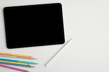 Tablet mockup and pencil for artwork presentation, colorful pencils, space for text, top view, digital art, drawing concept.