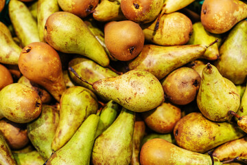 Lots of ripe pears. Wholesale and retail trade in fruit. Flat lay of the frame.